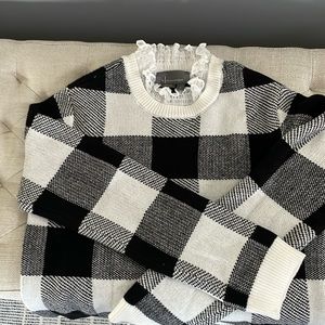 Black and white check sweater with ruffle collar